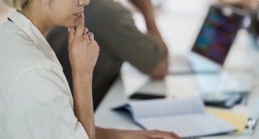Team members reviewing documents at a desk